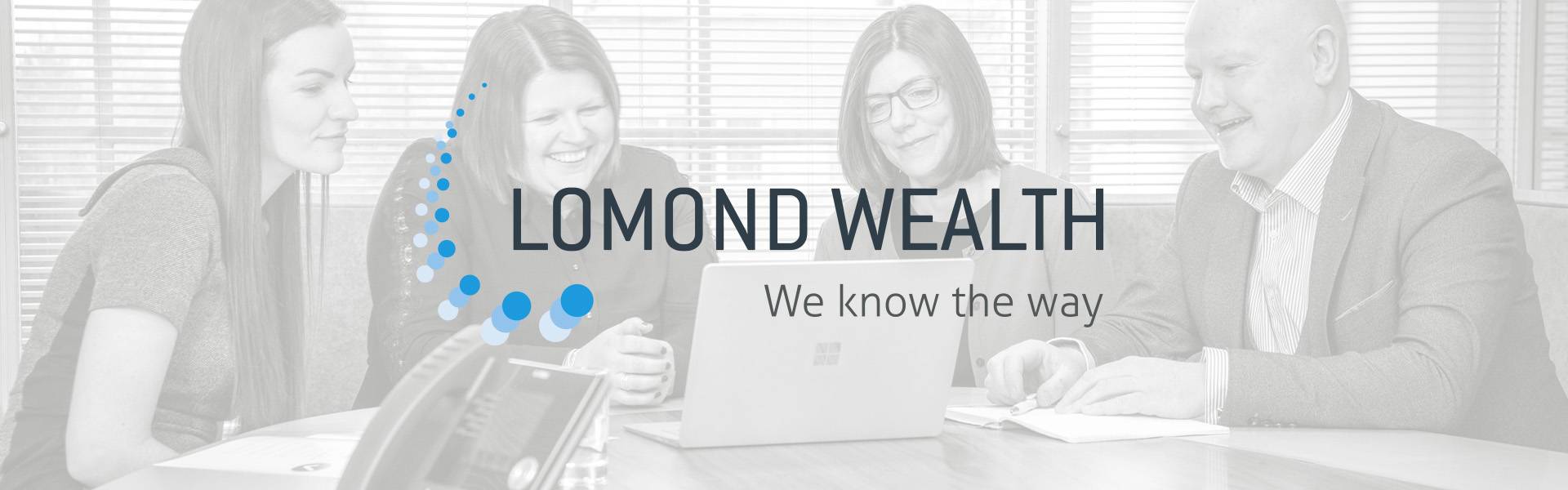 LWHeader Lomond Wealth Team Around a laptop, with the logo and tagline: We know the way, in the foreground